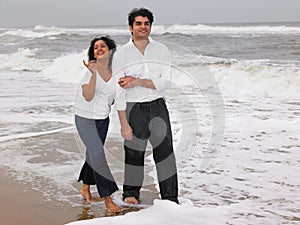 Asian couple walking in the beach