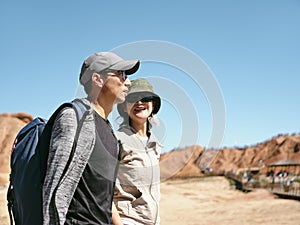 Asian couple walking in national park with yardang landforms