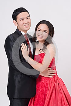 Asian couple wearing evening gown and dress.