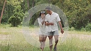 Asian couple young man and woman walking travel in forest happy romantic outdoor