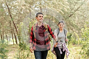 Asian couples, men holding hands, women walking Happily While traveling in the forest