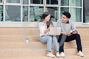 Asian couples students or colleagues sitting at the stairs and s