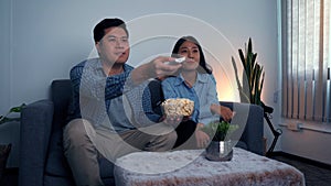 Asian couples watch movies on TV on weekends at night photo