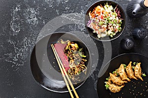 Asian cuisine dishes on the table overhead view