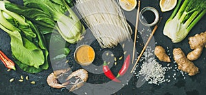 Asian cuisine ingredients over dark slate stone background, top view