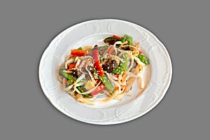 Asian cuisine, Wok noodle dish isolated on gray background, Chinese stir fried noodles with meat and vegetables