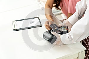 Asian customer make contactless credit crad payment close up