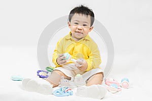 Asian cute baby boy about one year old in yellow shirt playing educational toys have fun smile and laugh happily isolated on white