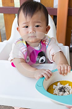 Asian cute baby eating food.