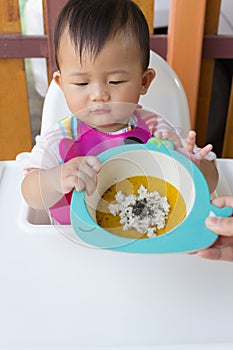 Asian cute baby eating food.