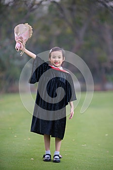 Asian cute child girl graduate. Girl smile on graduation kindergarten uniform