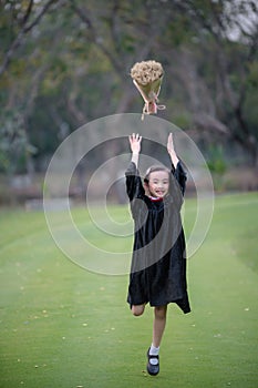 Asian cute child girl graduate. Girl smile on graduation kindergarten uniform