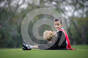 Asian cute child girl graduate. Girl smile on graduation kindergarten uniform