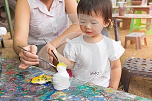 Asian cute girl baby and mother is painting colorful.