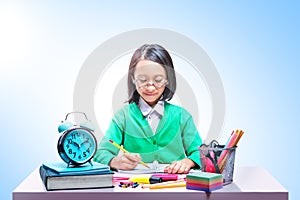 Asian cute girl in glasses learning with school stationary on the desk