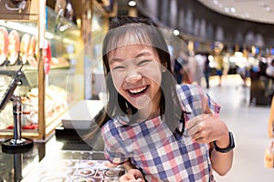 Asian cute girl happy and satisfied at food court in mall,delicious,yummy,tastes good