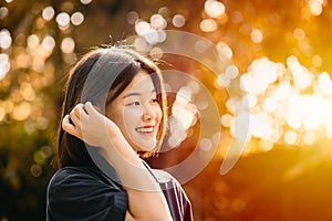 Asian cute girl teen innocent shy smiling happiness moment with nature sunshine beautiful background