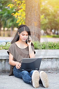 Asian Cute teen women calling smartphone and laptop modern lifestyle.