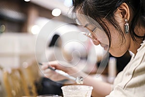 Asian cute woman drinking chocolate frappe in cafe shop photo