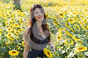 Asian cute young woman joyful, smiling with sunflowers background