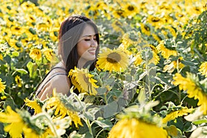 Asian cute young woman joyful, smiling with sunflowers background