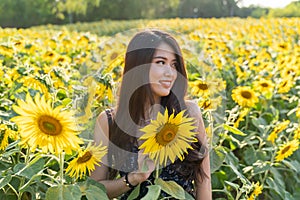 Asian cute young woman joyful, smiling with sunflowers background