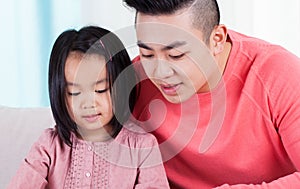 Asian dad spending time with daughter