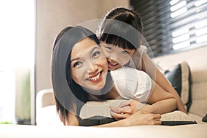 Asian daughter hugs mother