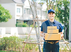 Asian deliver man in blue uniform holding package box