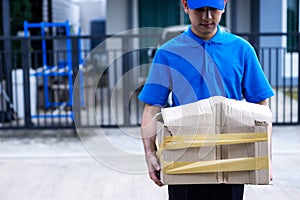 Asian delivery man in blue uniform he emotional falling courier courier showing damaged box, cheap parcel delivery, poor shipment