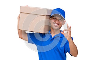 Asian delivery man carrying a parcel box and giving OK sign