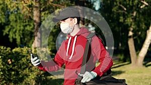 Asian delivery man in red uniform with face mask carrying bag of food delivering food to customer home during covid