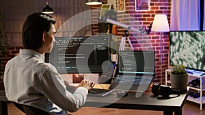 Asian developer programming code on firewall server