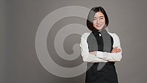 Asian diner employee prepared to serve food at tables