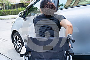 Asian disability woman on wheelchair getting in her car. Accessibility concept