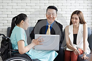 Asian disabled businesswoman in wheelchair, she is presenting her job on a laptop