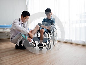 Asian disabled child visit paediatrician doctor to check ankle and leg pain from accident for recovery body and plan physical