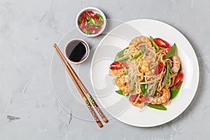 Asian dish of fried rice noodles with shrimp and vegetables. The view from the top. Copy-space.