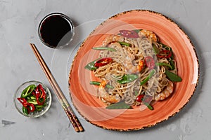 Asian dish of fried rice noodles with shrimp and vegetables. The view from the top. Copy-space.