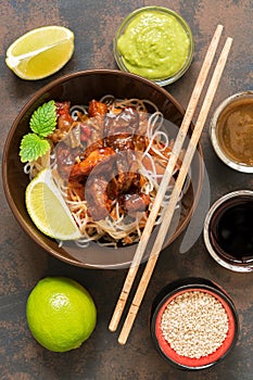 Asian dish glass noodles with vegetables and meat. Pork fried with sweet sour sauce. Stir-Fred