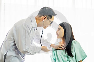 Asian doctor checked the female patient`s fever and explain treatment the sick patient on the hospital, Medical healthcare concept