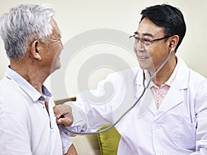 Asian doctor checking senior patient