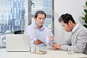 Asian doctor consults young patient
