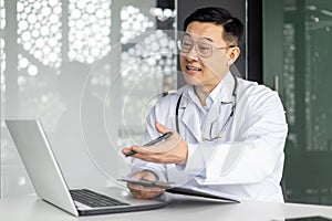 Asian doctor discussing healthcare with patient online