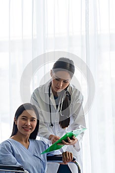 Asian doctor explaining diagnosis to her female patient