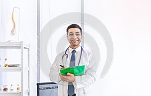 Asian doctor in gown uniform working with happiness smiling at hospital or medical clinic