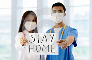 Asian doctor or nurse with Stay Home sign