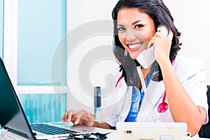 Asian doctor in office administration work