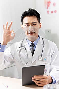 Asian doctor with ok gesture