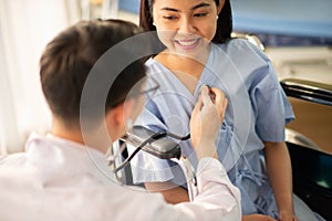 Asian Doctor and patient talking and checking  health care medical sickness at hospital